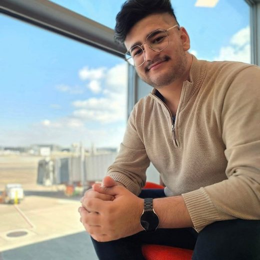 Aaryan Dhakal, back-end software engineer, sitting by an airport window